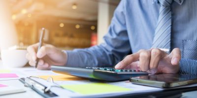 Business finance man calculating budget numbers, Invoices and financial adviser working.